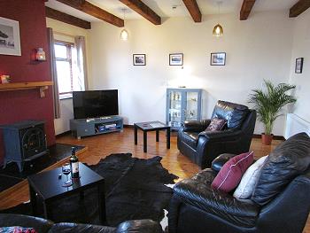 The sitting room with large flat screen TV